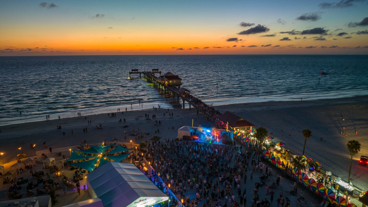 Aerial photo of Clearwater Beach at sunset with the Sugar Sand Festival happening on the beach in the foreground.