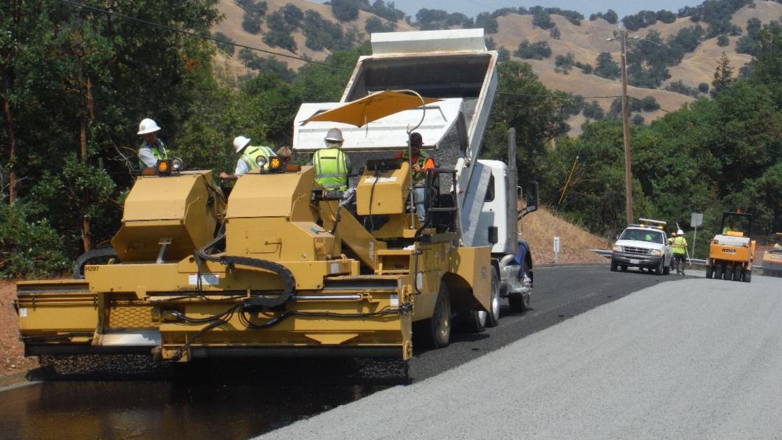 Photo of a Sonoma County pavement construction crew working on a road in a truck laying pavement