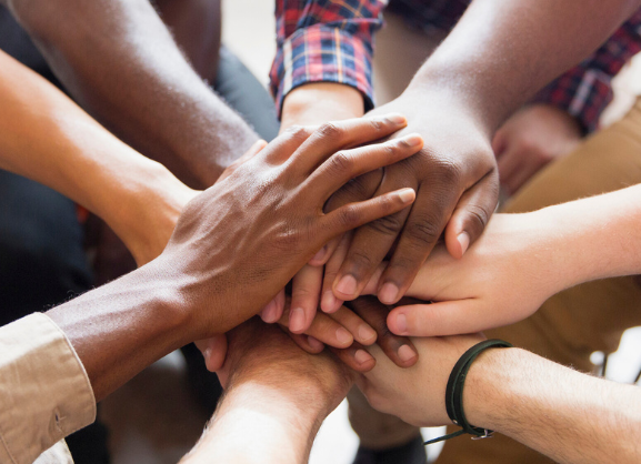 Hands in a group supporting each other