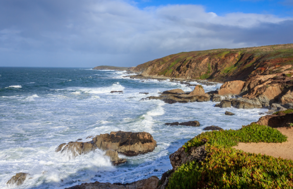 Photo of Bodega Bay water and cliffs on a cloudy day