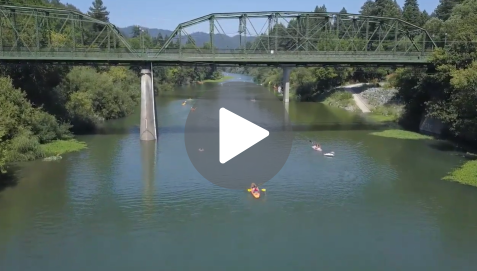 Image of bridge over river with play arrow. Click to watch or listen to video.