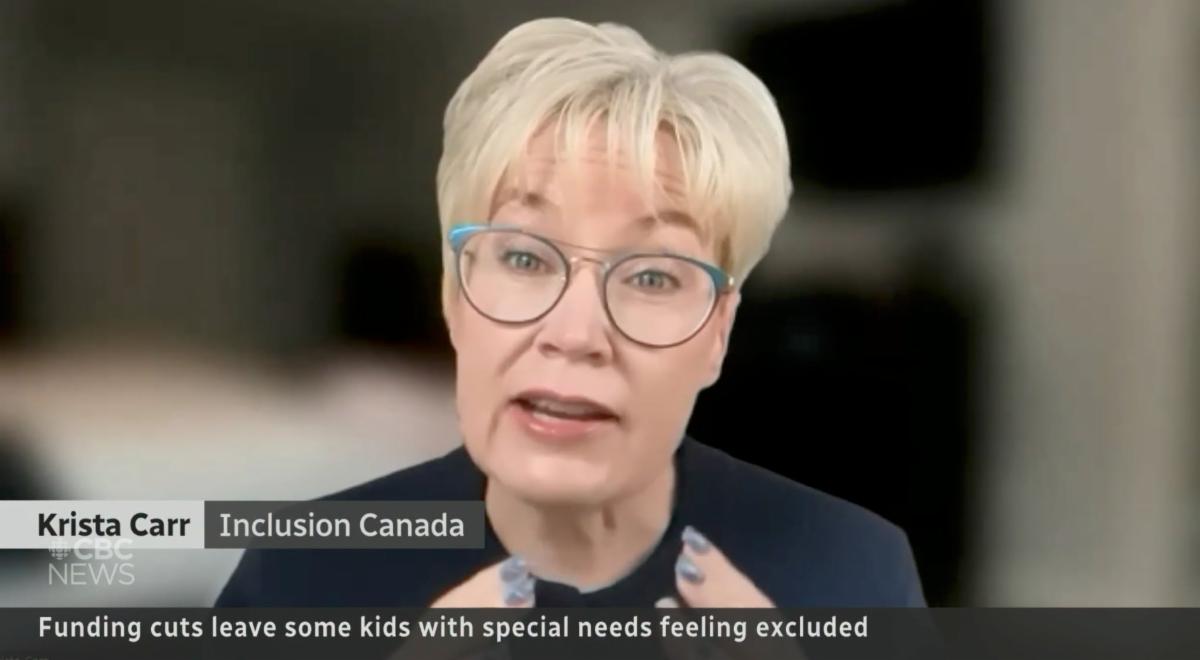 Krista Carr, CEO of Inclusion Canada, speaking during a CBC News interview. She is shown wearing glasses and a dark blazer, with a blurred indoor background. On-screen text identifies her as “Krista Carr, Inclusion Canada” and reads “Funding cuts leave some kids with special needs feeling excluded.”