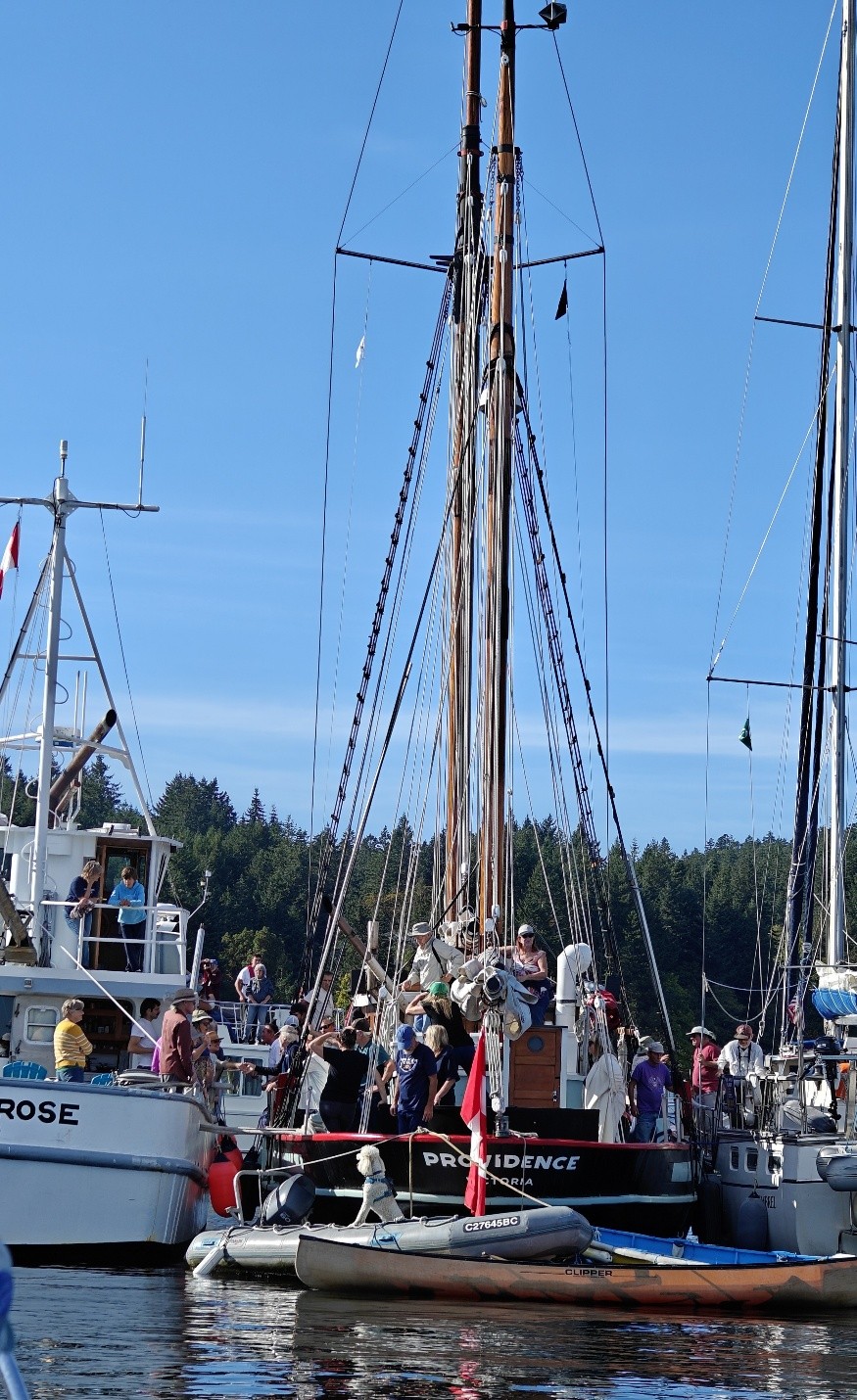 three large vessels raft together on the water so people can shake hands