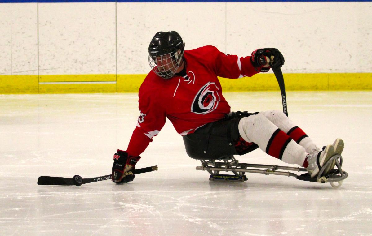 Sled hockey player catching the puck