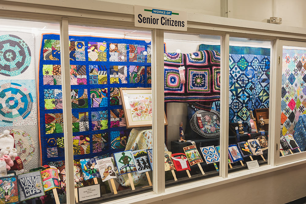A display case in the Creative Activities Building holding quilt entries.