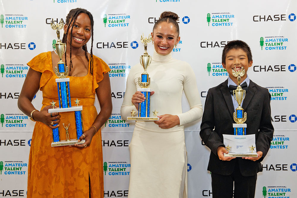 Two young girls dig in the dirt at the Little Farm Hands exhibit