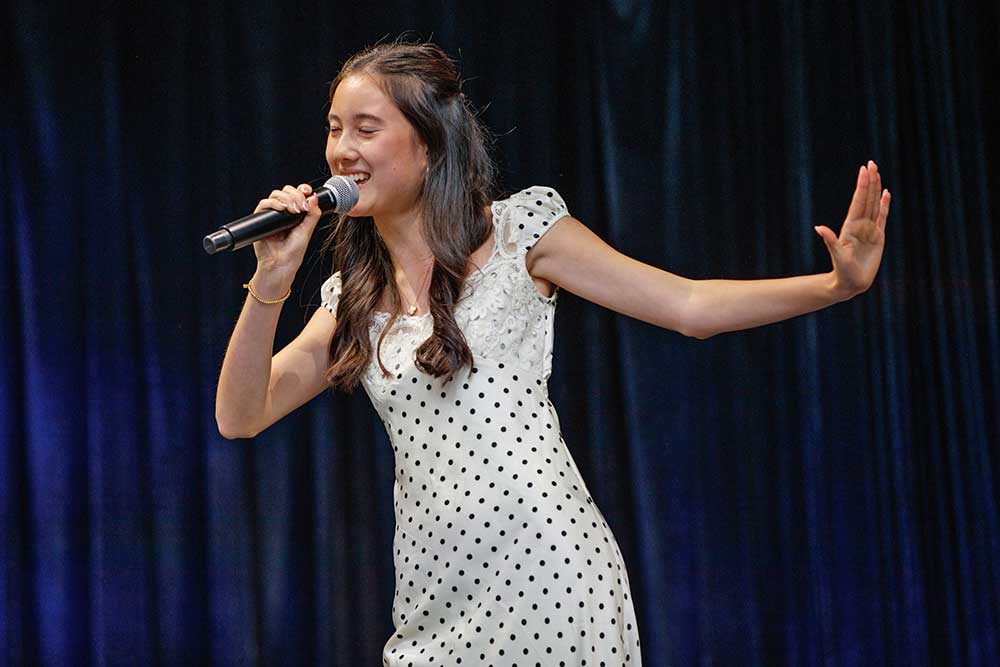 A singer participating in the Amateur Talent Contest auditions.