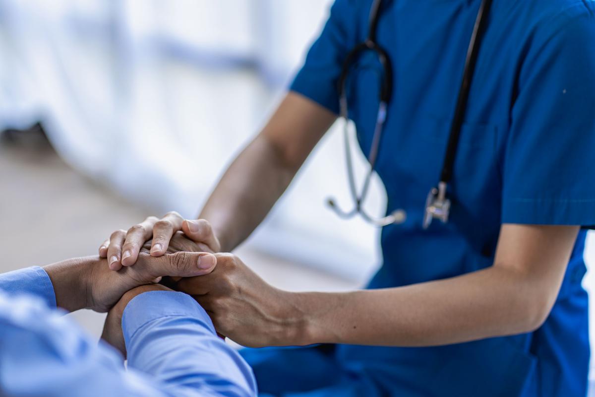 Doctor holding patient's hand