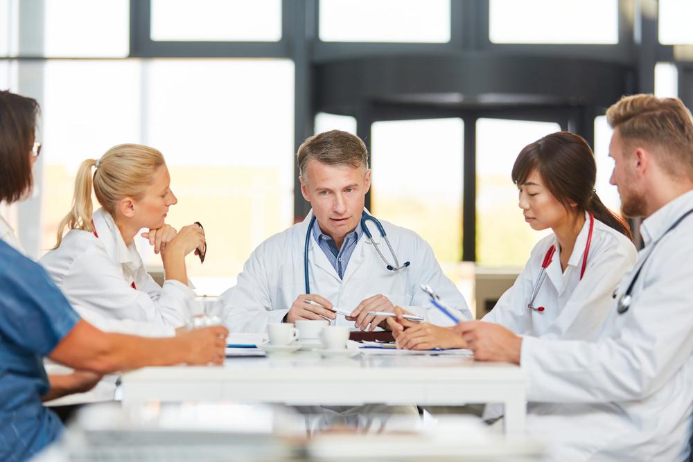 Physicians at a table talking