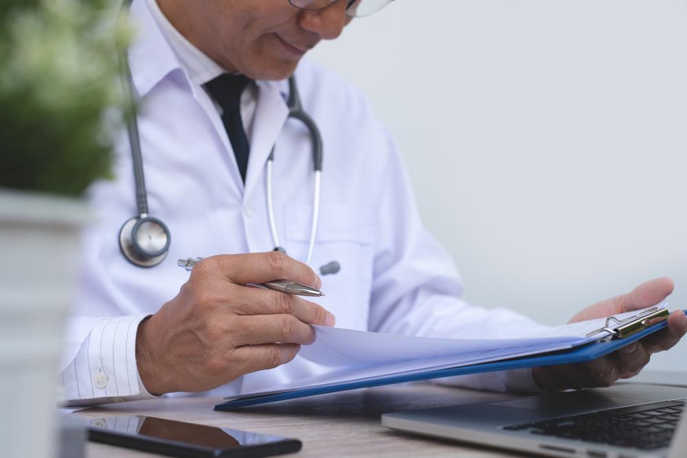 male doctor reviewing paperwork