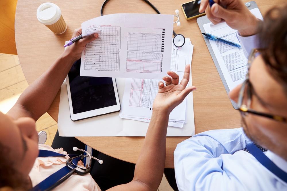 Overhead shot of doctors consulting over patient
