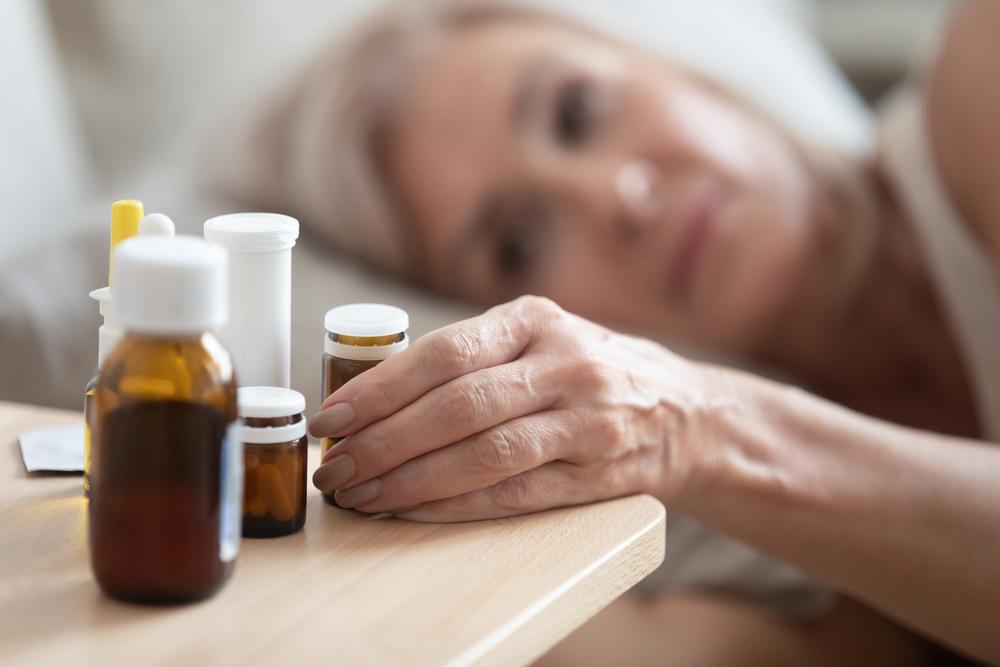 closeup of older womans hand on medication