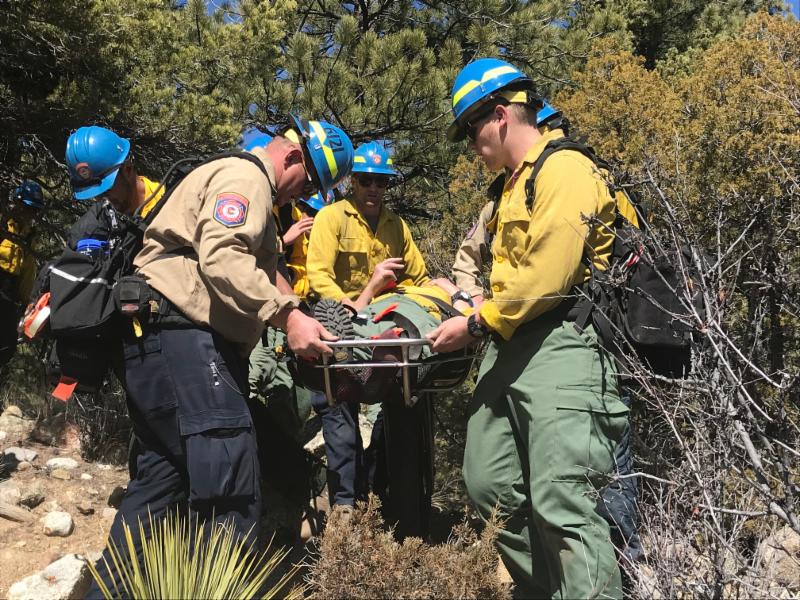 DFPC wildland firefighters practice carrying an injured team member