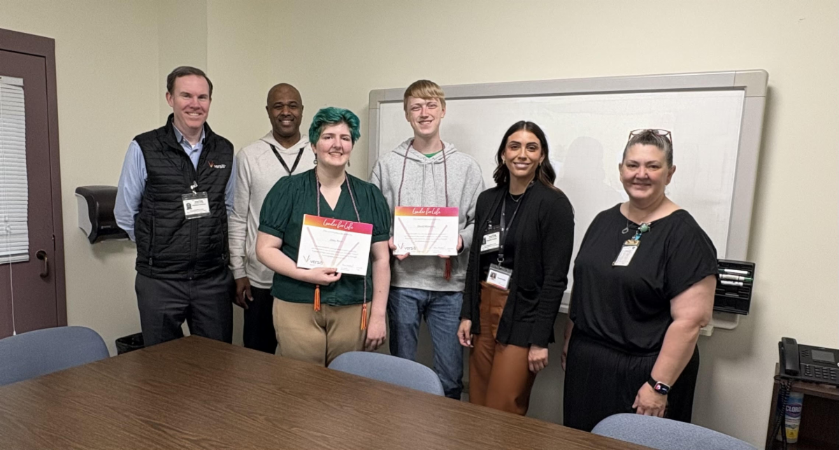 Representatives from Versiti Blood Center pose with students and certificates of acheivement