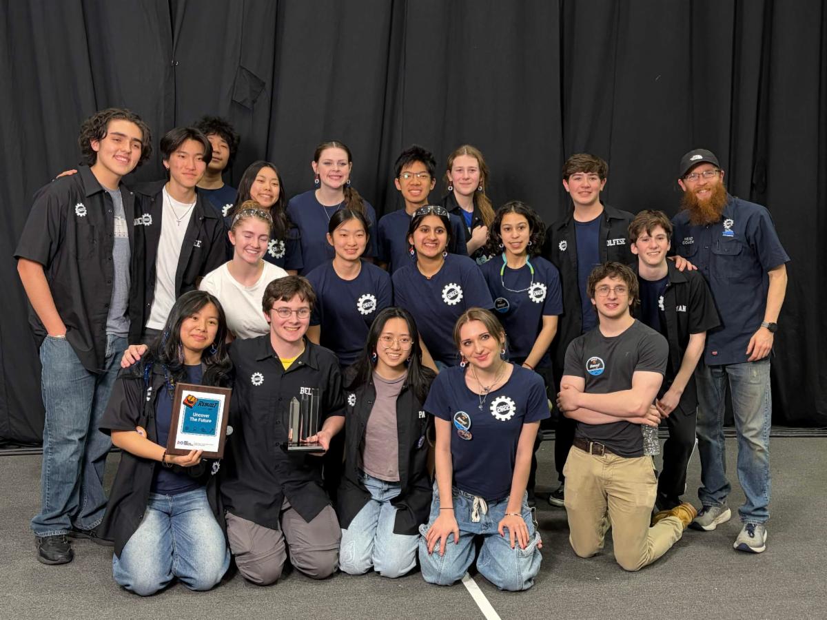 IMSAâs Titan Robotics team poses together on stage, holding a plaque and award while celebrating their recent competition win.