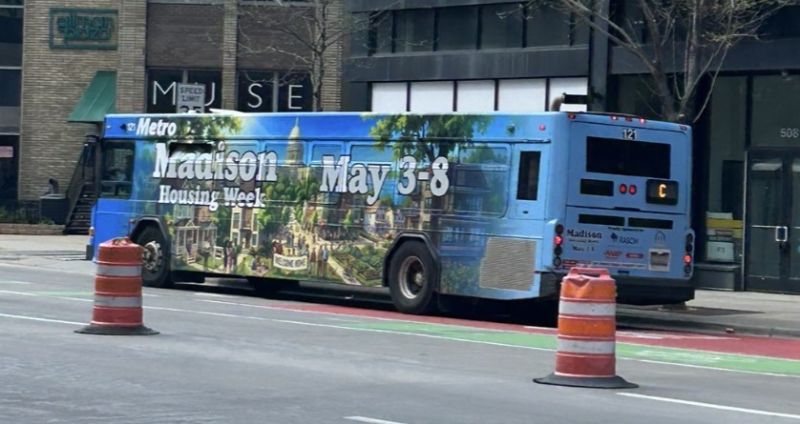Madison City Bus wrapped with advertisement for Madison Housing Week