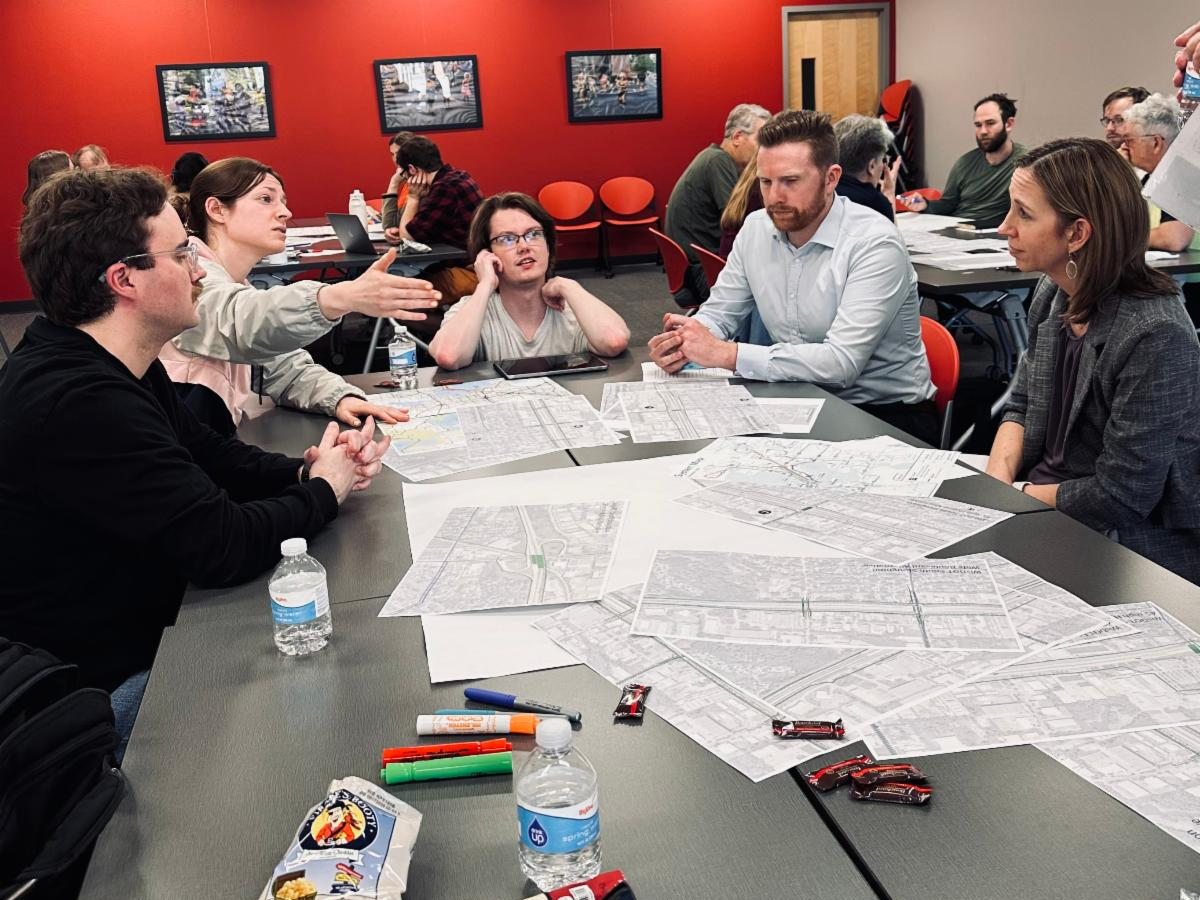 Participants analyze maps as part of the Madison Community Transportation Academy