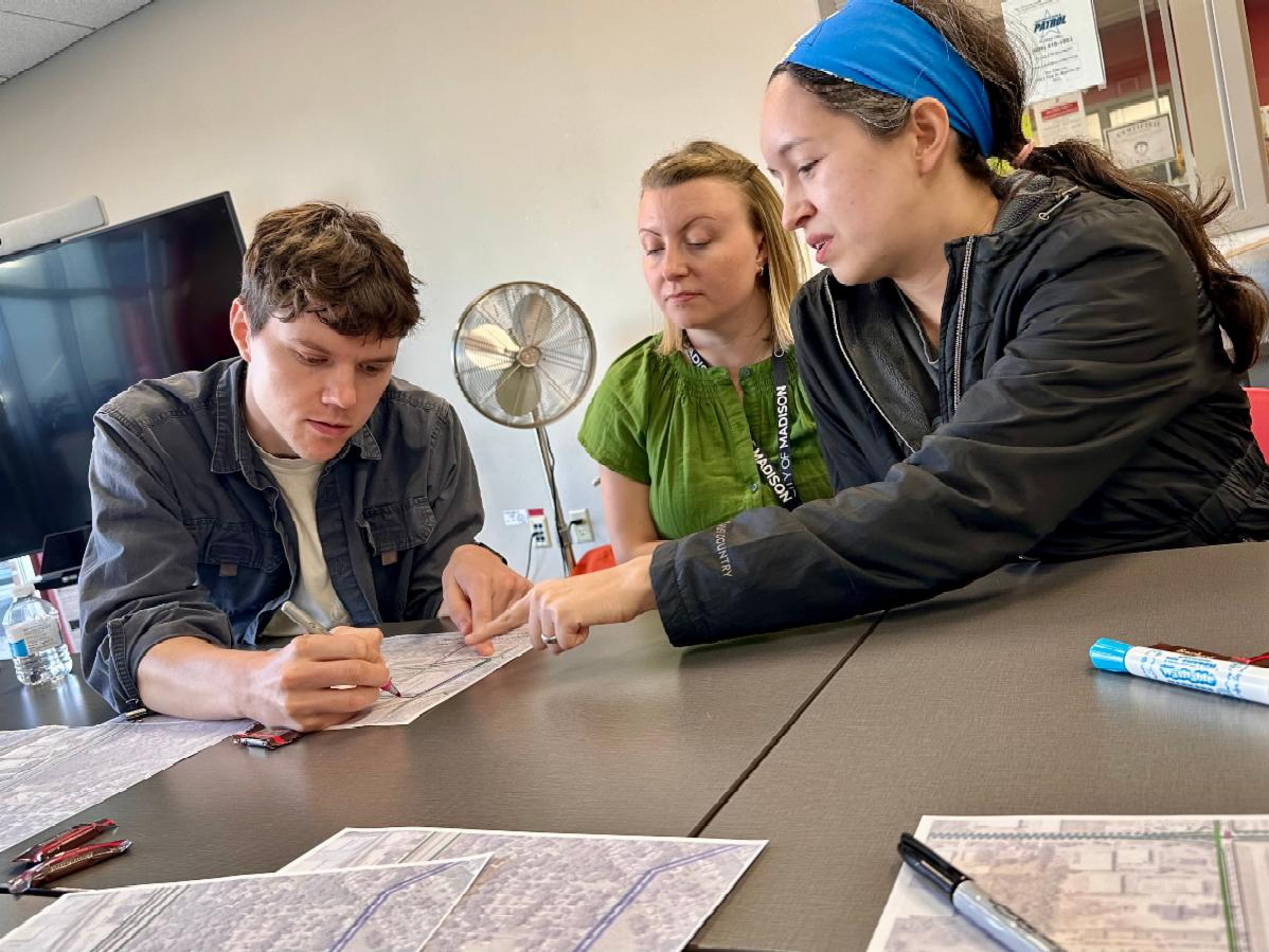 Participants analyze maps as part of the Madison Community Transportation Academy