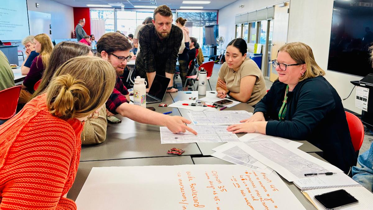 Participants analyze maps as part of the Madison Community Transportation Academy