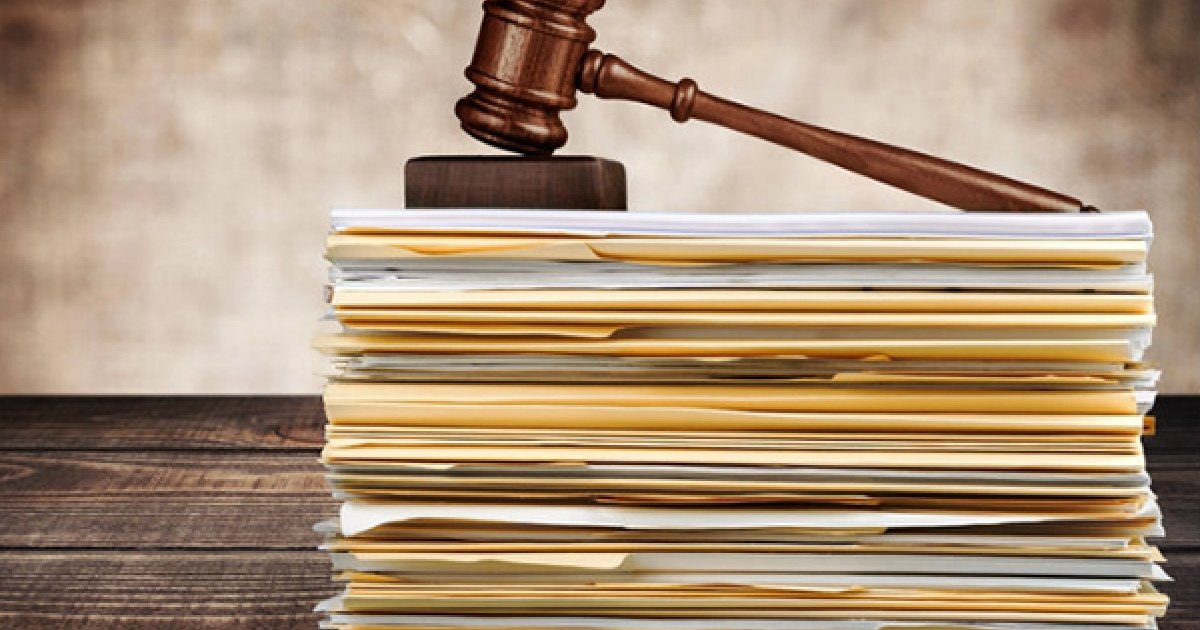 Stack of Paper/Folders representing pending legislation with gavel to represent law