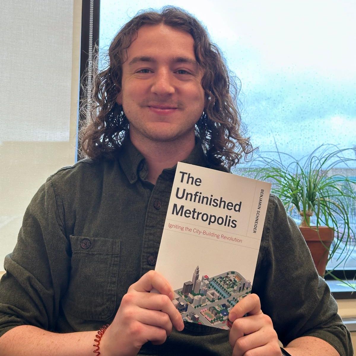 Winner Travis Key pictured with The Unfinished Metropolis Book