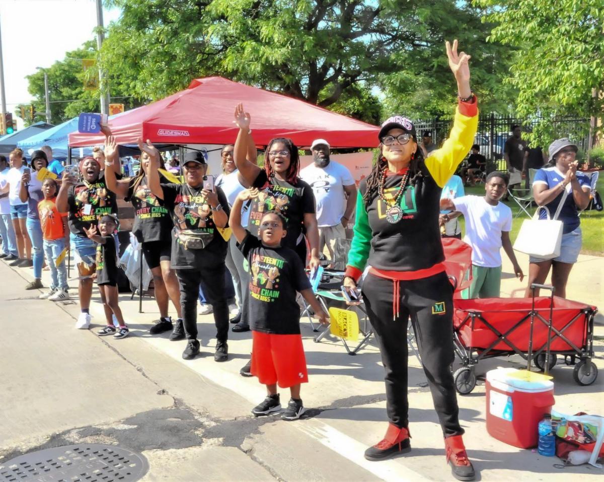 Community members cheering during Juneteenth parade in Milwaukee, Wisconsin
