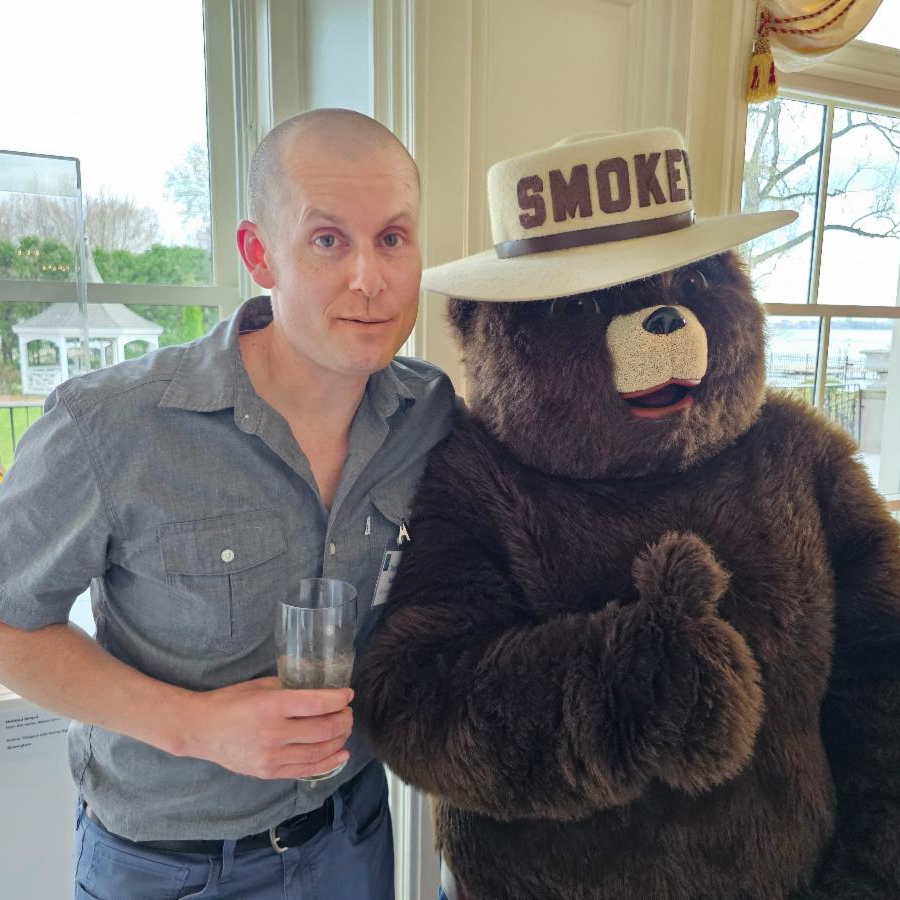 Trevor Roark (left) poses with Smokey the Bear (right) at the Earth Day Event