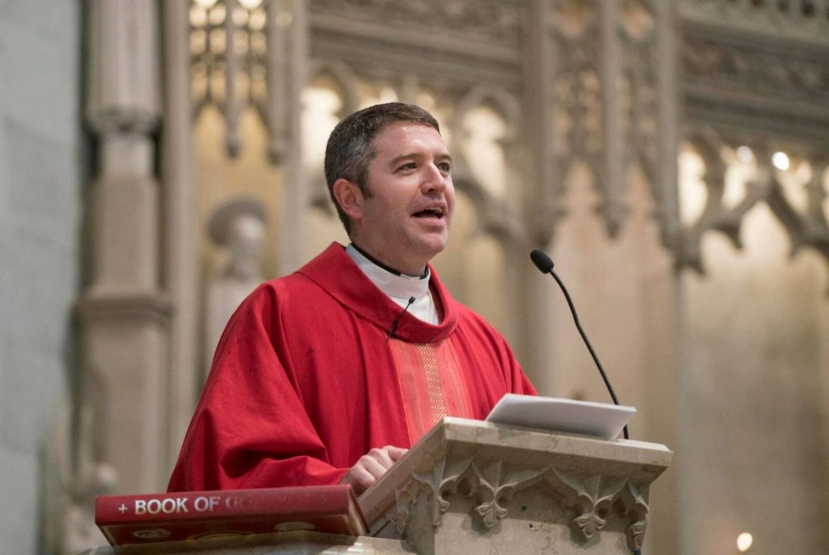 white male priest speaking at pulpit in church