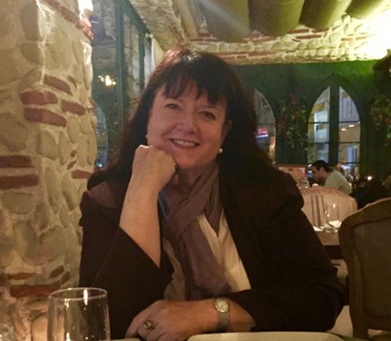 smiling woman sitting at table