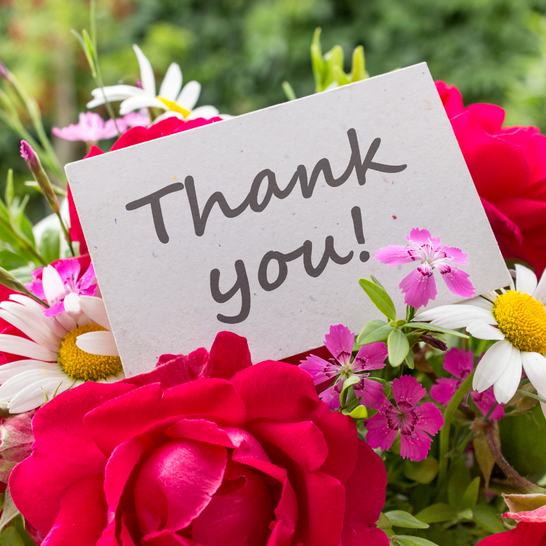 pink and white floers with a note saying thank you