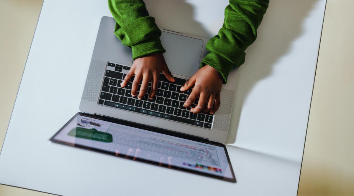 A child types on a computer