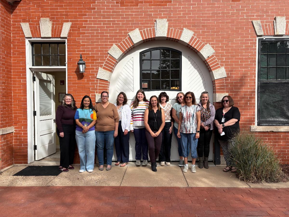 Wyoming family leaders and maternal and child health team members gathered in front of the Wyoming Historic Governor's Mansion Carriage House.