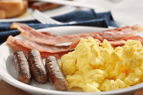 Scrambled eggs, sausage, and bacon