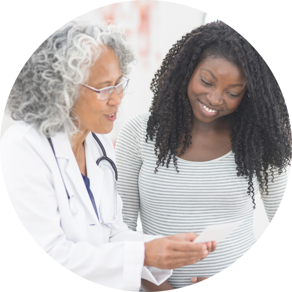 Pregnant woman at doctor's office stock photo