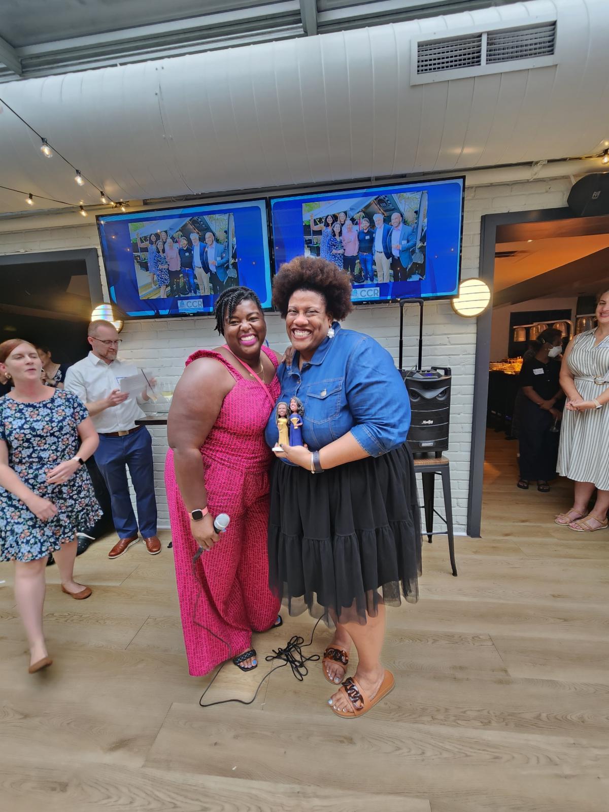2.	CCR Auxiliary Board Member Tynisha Singletary presents an award to fellow AB member Jessica Sullivan-Wilson for outstanding work towards CCR_s Annual Event Silent Auction