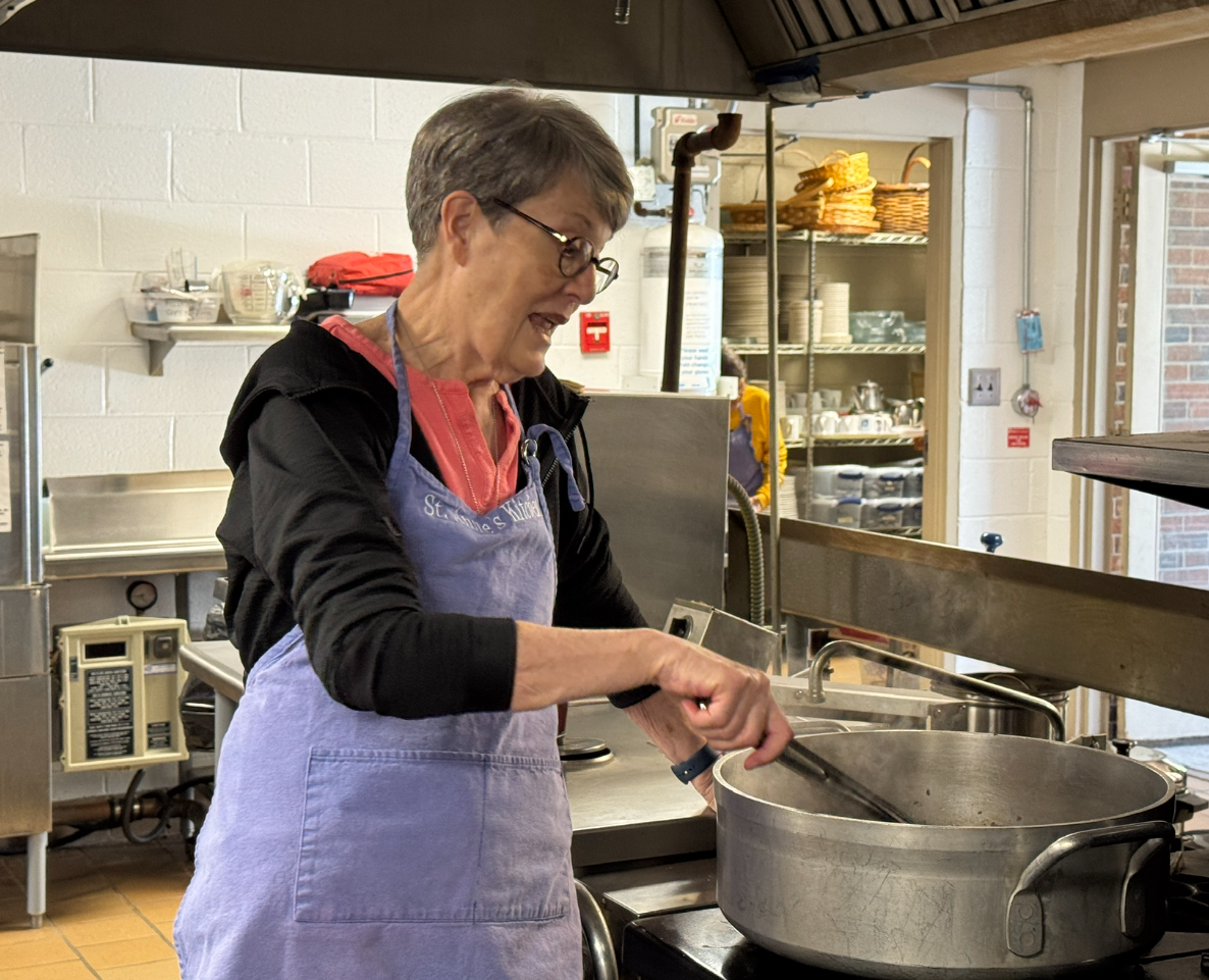 Stirring up dinner for Holy Comforter