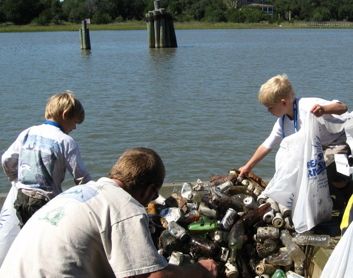Volunteers sorting plastics and bottles