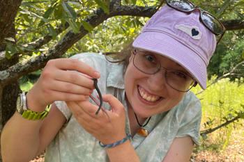 PEEC graduate holds a non-venomous snake