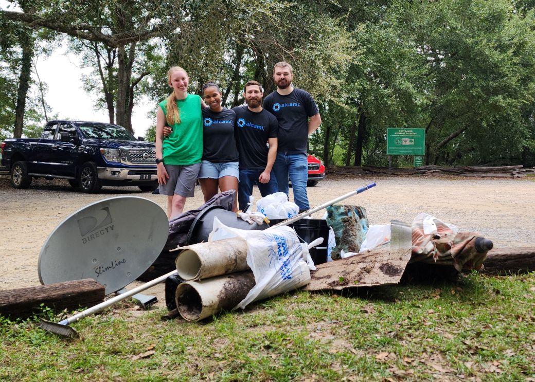 Volunteers stand behind 70 pounds of debris removed from Fort Lamar Heritage Preserve on James Island S.C.