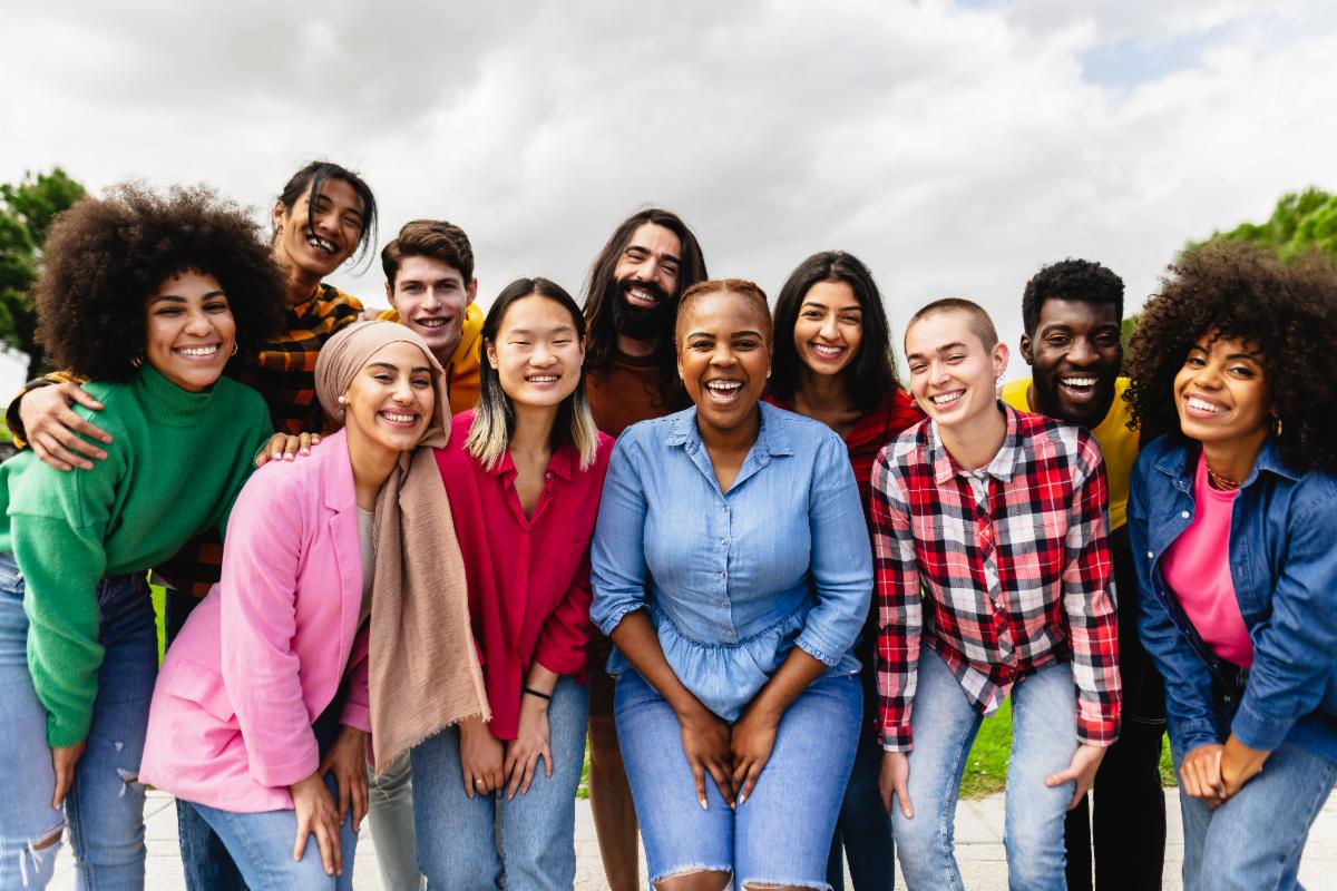 A group of youth in an outdoor setting taking a picture.
