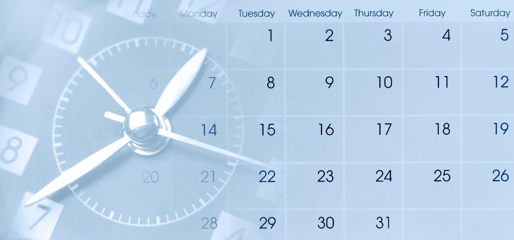 Stock image of a monthly calendar with a clock image embedded and days and dates.