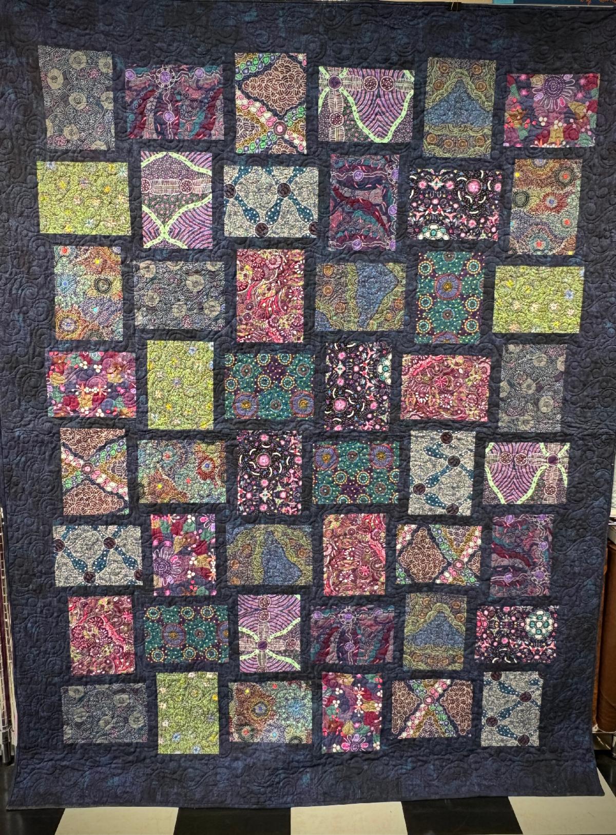 Australian Bounty multicolored quilt on a dark background