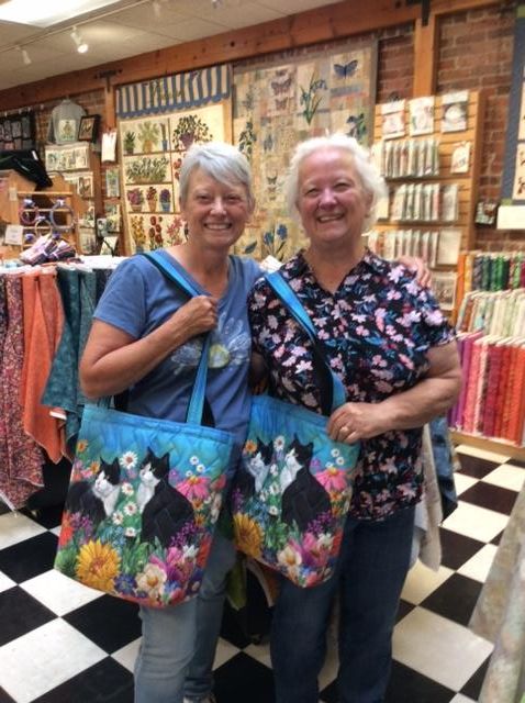 Sew Creative customers with colorful handmade tote bags