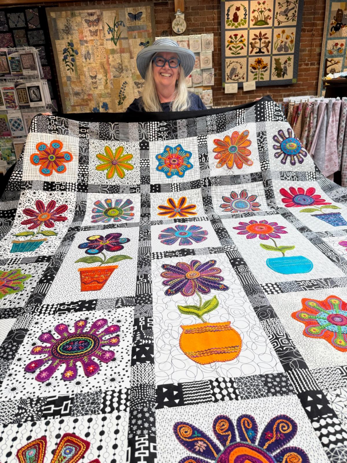 Joanne with her Flower Power quilt