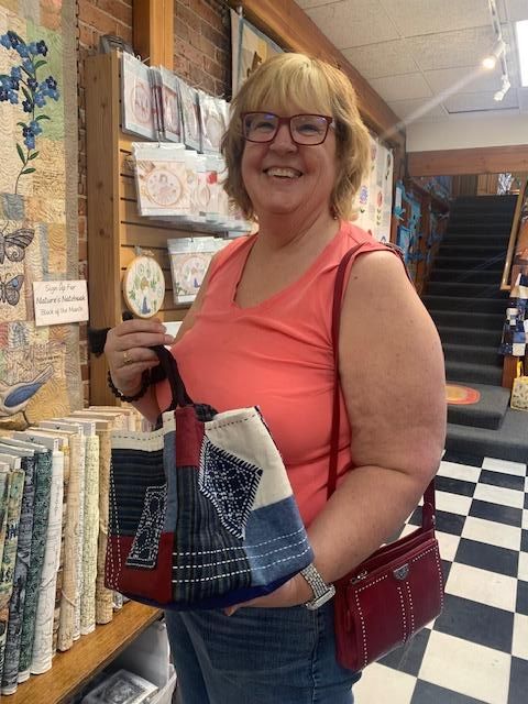 Customer showing her handmade Rice Bag at Sew Creative