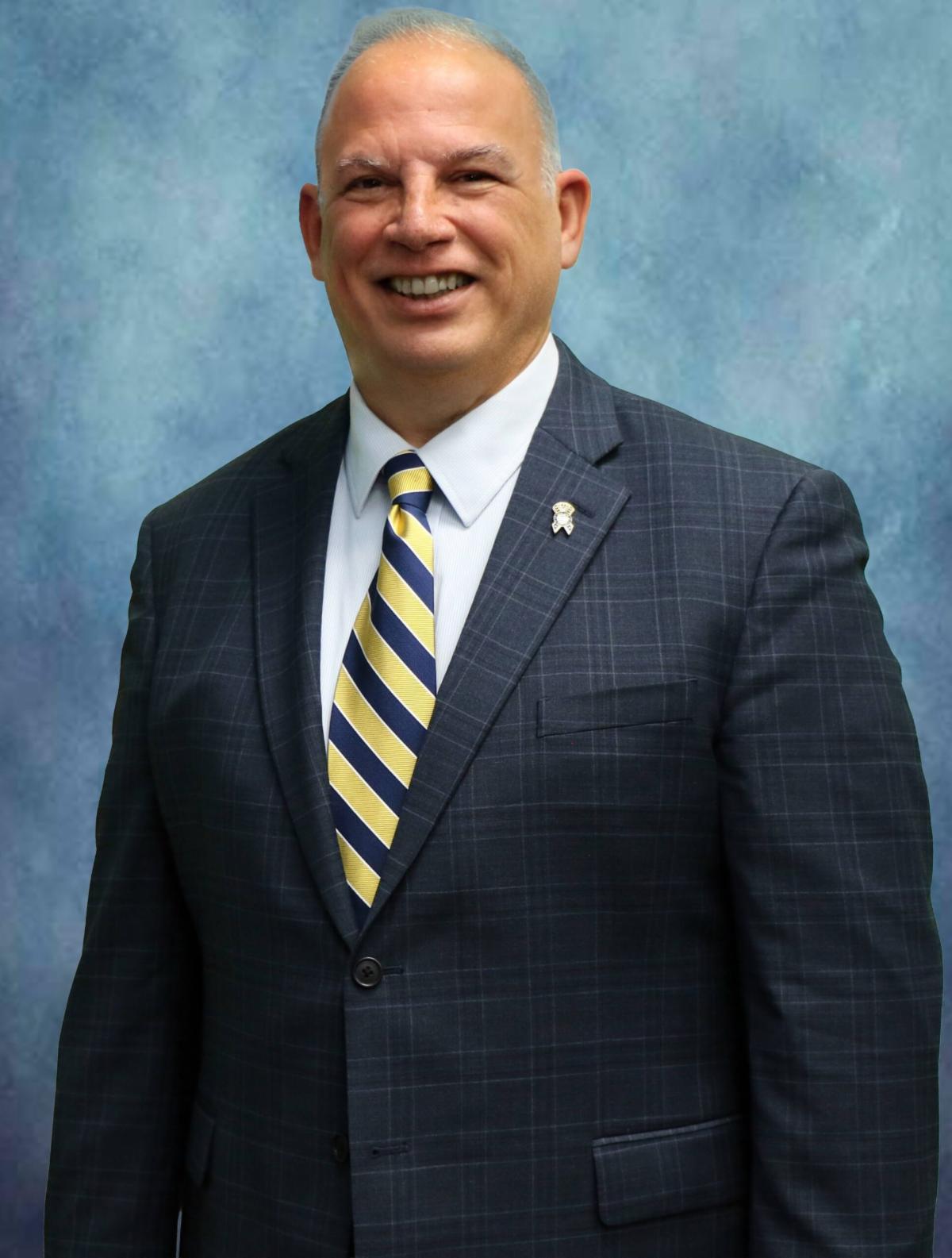 A professional portrait of Ed Rothstein a man in a business suit.