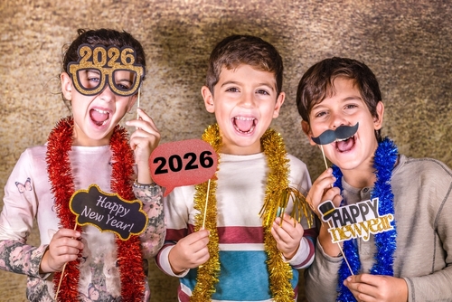 Three kids celebrating New Years Eve. 2026 