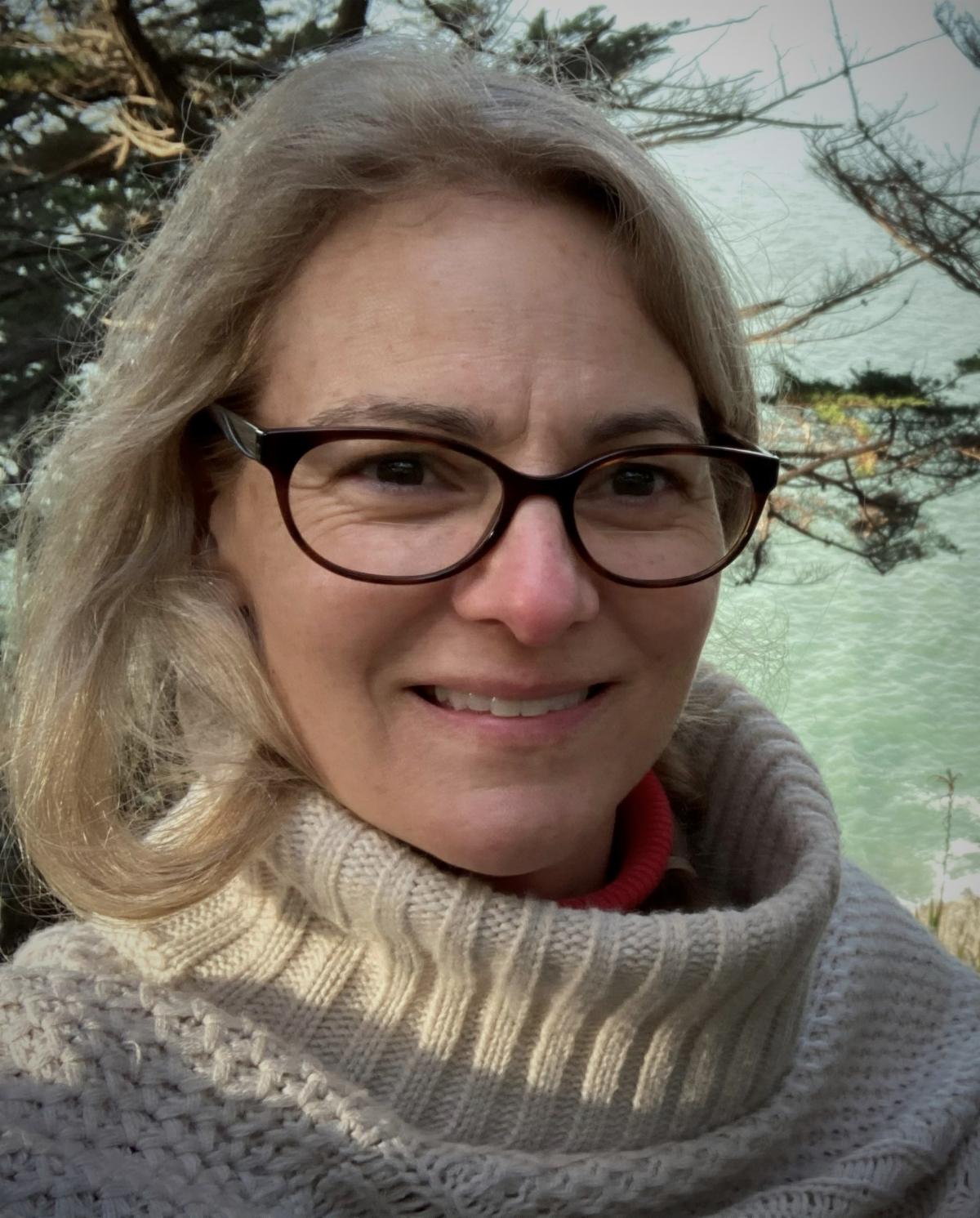 R.Martin smiling woman with glasses