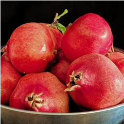 bowl of red round pomegranates