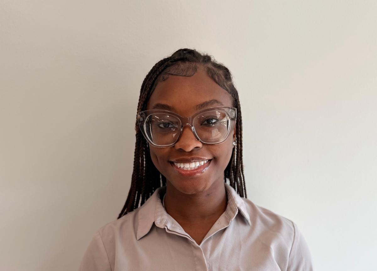 African American woman wearing glasses smiling for the camera